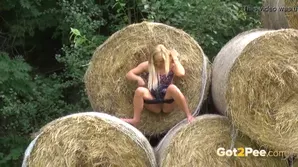 A blonde in the yard of a farmer heated